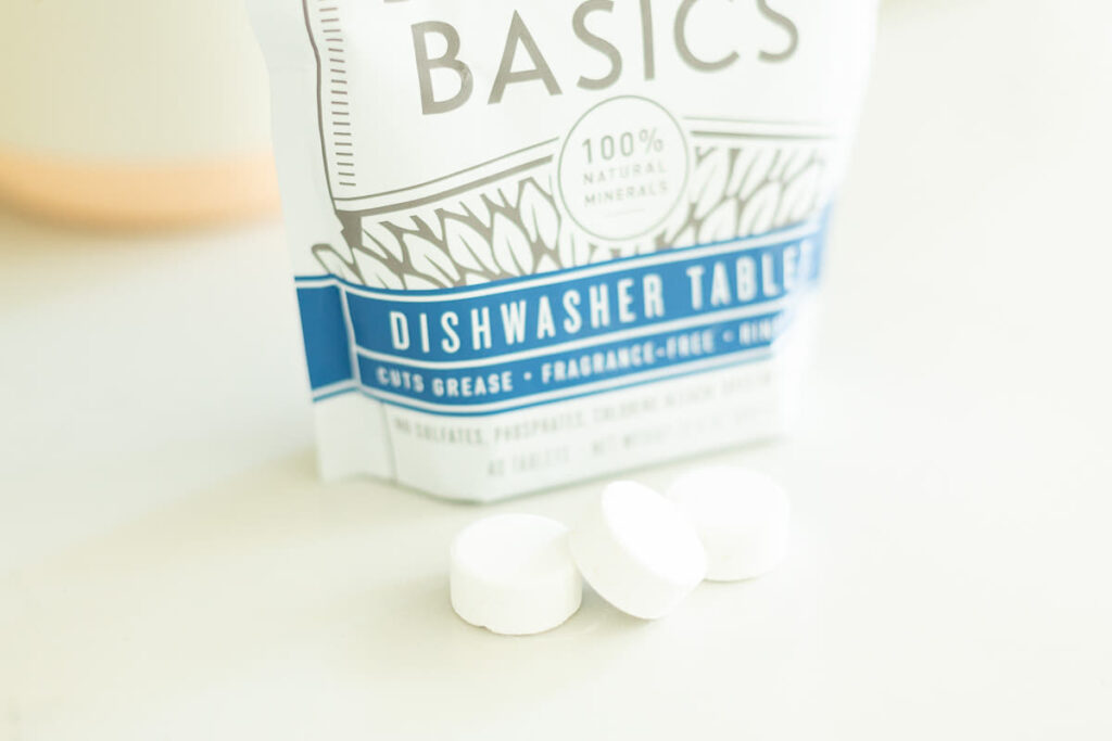 Close-up of Branch Basics dishwasher tablets with bag in the background